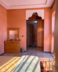 a bedroom with a bed and a dresser and a mirror at Charming Family Villa with Private Pool & Garden - Near Marrakech in Sraïri