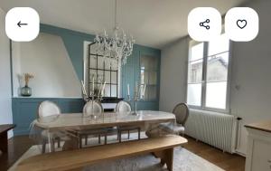 a dining room with a table and a mirror at Chez Mary in Larzicourt +15 photos