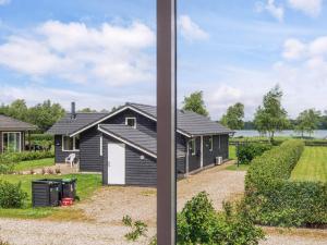 a view of a house from a window at Scandinavian Lakeside Retreat-By Traum in Ansager +30 photos
