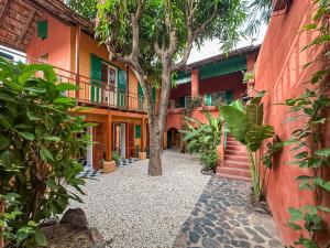 a courtyard of a house with a tree at Maison Crespin in Dakar