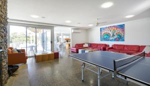 a living room with a ping pong table in it at The Island Accommodation in Phillip Island