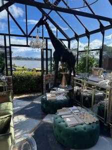a room with a statue of a giraffe in a tent at La Belle Maison in Tauranga