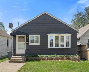 a black house with a white door at MINT 3Bedroom Home Perfect for long stay! in Windsor