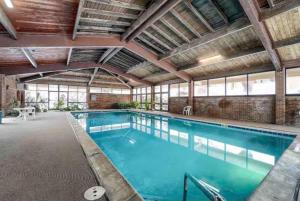 a large indoor swimming pool with a brick wall at Boulder Basecamp - Cozy 2BR Near Trails & Town 