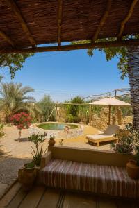 a view of a pool with a table and an umbrella at Soléi Salt Caves in Siwa +7 photos