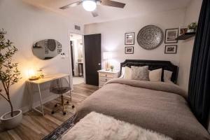 a bedroom with a bed and a desk and a table at Cactus Luxury, Comfort, and Amenities galore! in Scottsdale