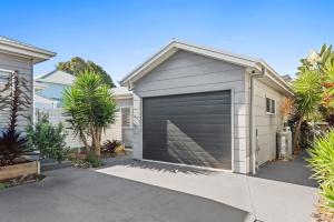 a garage door on the side of a house at Sunny Townhouse in Huskisson