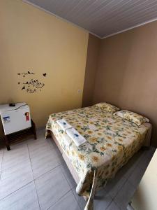 a small bedroom with a bed and a table at Pousada Maré do Cerrado in Mateiros +21 photos
