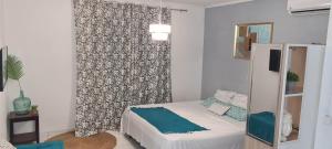 a bedroom with a bed and a wall at Paradies Caraïbes III in Les Abymes