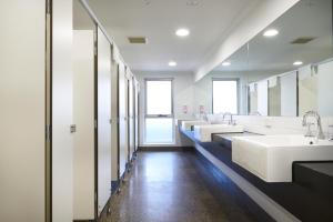 a bathroom with three sinks and a row of mirrors at The Island Accommodation in Phillip Island +132 photos