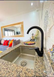 a kitchen with a sink with a faucet at Mira bay surf house in Imsouane
