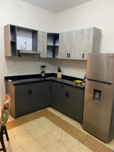 a kitchen with a refrigerator and a counter top at Mereri downtown appartments in Oranjestad