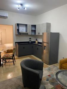 a kitchen with a stainless steel refrigerator in a room at Mereri downtown appartments in Oranjestad +10 photos