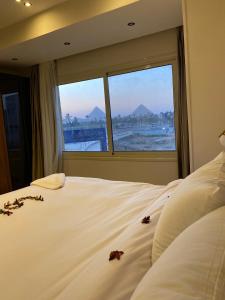 a bedroom with a bed with some flowers on it at New Galleria Pyramids view inn in Cairo