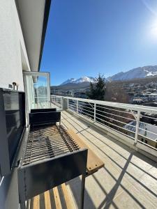 a balcony with a bench on top of a building at Apart Gob Campos con vista in Ushuaia