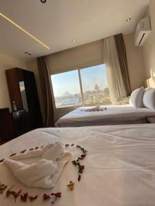 a hotel room with a bed with flowers on it at New Galleria Pyramids Hotel in Cairo