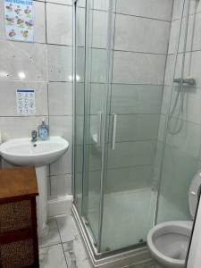 a bathroom with a glass shower and a sink at Twin Room on Green Road in Dudley +53 photos