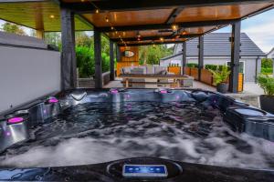 a hot tub on the patio of a house at Rosies Cottage in Rostrevor