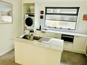 a kitchen with a sink and a microwave at Heart of Mornington in Mornington +7 photos
