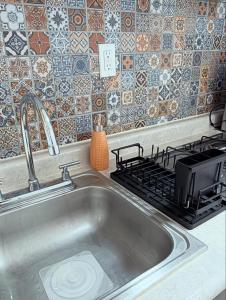 a sink in a kitchen with a stove at Dorotea Apartment in San Miguel de Allende