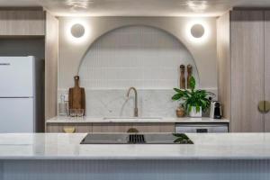 a kitchen with a sink and a counter top at Luxury Living on Monaco Riverfront - Hosted by Coastal Letting Co. in Gold Coast