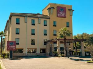 a hotel with a sign that reads center suites at Brunswick Suites Golden Isles Gateway I-95 in Brunswick