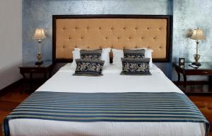 a bedroom with a large bed with two pillows at Hotel Celeste Makati in Manila