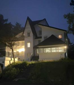 a white house at night with the lights on at Nona Madarao in Madarao Kogen +31 photos