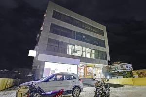 a car parked in front of a building at night at Townhouse OAK Hi-City in Kamakhya