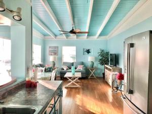 a living room with a couch and a ceiling fan at Pineapple Cottage 2 bedroom in Jensen Beach
