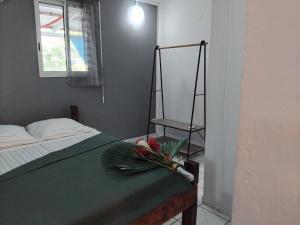 a bedroom with a bed with a bouquet of flowers on it at Résidence Belle Place Palmier in Saint-François