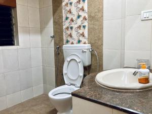 a bathroom with a toilet and a sink at Good stay Nungambakkam in Chennai