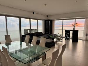 a living room with a glass table and chairs at Icon Vallarta in Puerto Vallarta