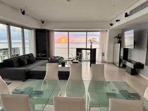 a living room with a glass table and chairs at Icon Vallarta in Puerto Vallarta