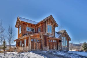 a large wooden house in the snow at Barnwood Beauty at Grand Elk- Pet Friendly- Hot Tub Private Golf Ski Games in Granby