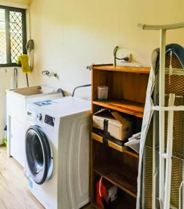 a laundry room with a washing machine in it at Entire independent 3 bdrm house in Algester