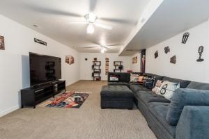 a living room with a couch and a flat screen tv at Hyde Park Haven - your home away from home - minutes north of Logan and USU in Hyde Park