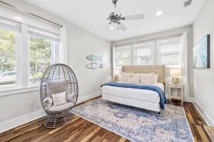 a bedroom with a bed and a chair and windows at Soakin it Up in Inlet Beach +74 photos
