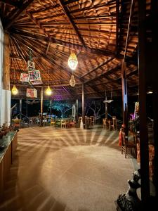 a large room with a stage with tables and chairs at Pousada Vila Mara do Sertão in Buíque