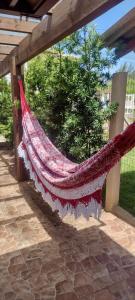 a hammock is hanging from a pergola at Casa de Praia da Família Martins in Tramandaí