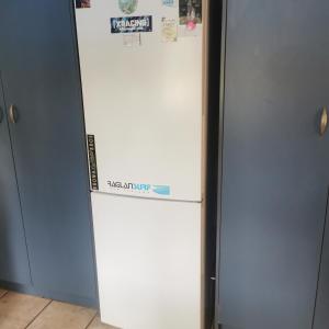 a white refrigerator with magnets and papers on it at Double Room Free WIFI in Hamilton