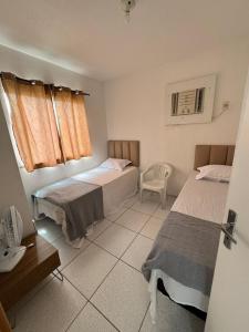 Ένα ή περισσότερα κρεβάτια σε δωμάτιο στο Apartamento Mobiliado para seu conforto