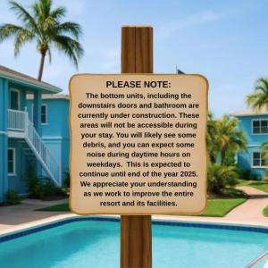 a sign in front of a swimming pool at The Aura a Luxury Waterview Condo & heated pool in Clearwater Beach
