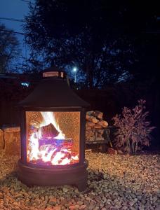 a lantern with a fire in a yard at night at Su Casa Studio in Denver