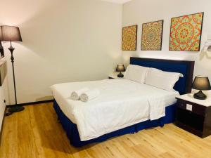 a bedroom with a bed with two towels on it at City Homestay in Miri +3 photos