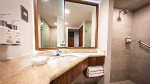 a bathroom with a sink and a mirror and a shower at Holiday Inn Orizaba by IHG in Orizaba