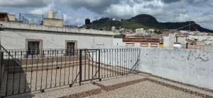 a fence on top of a building with a city at Céntrico in Zacatecas