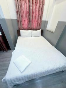 Кровать или кровати в номере Nhà Nghỉ Minh Châu Biên Hòa