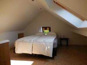 a bedroom with a bed in a attic at Le Ru du Passage in Sart-lez-Spa