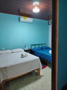a room with two beds and a table in a room at Casa Marina in Pedregal